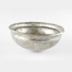 A silver bowl, with a slightly raised lip at the top