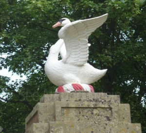 A cast iron swan on top of a gate post