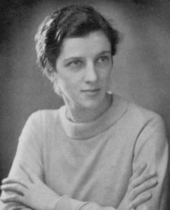 Photo of a thoughtful looking young woman, wearing a high-necked jumper