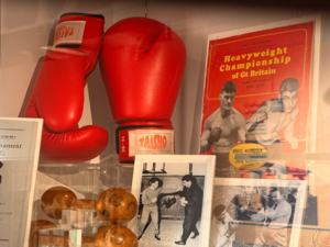 Image of boxing gloves and boxing programmes on display in Harborough Museum