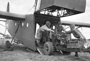 Three men loading a machine into a glider